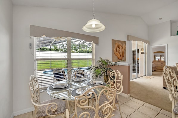 Enjoy meals with friends and family in this dining area, featuring a round table and comfortable chairs.