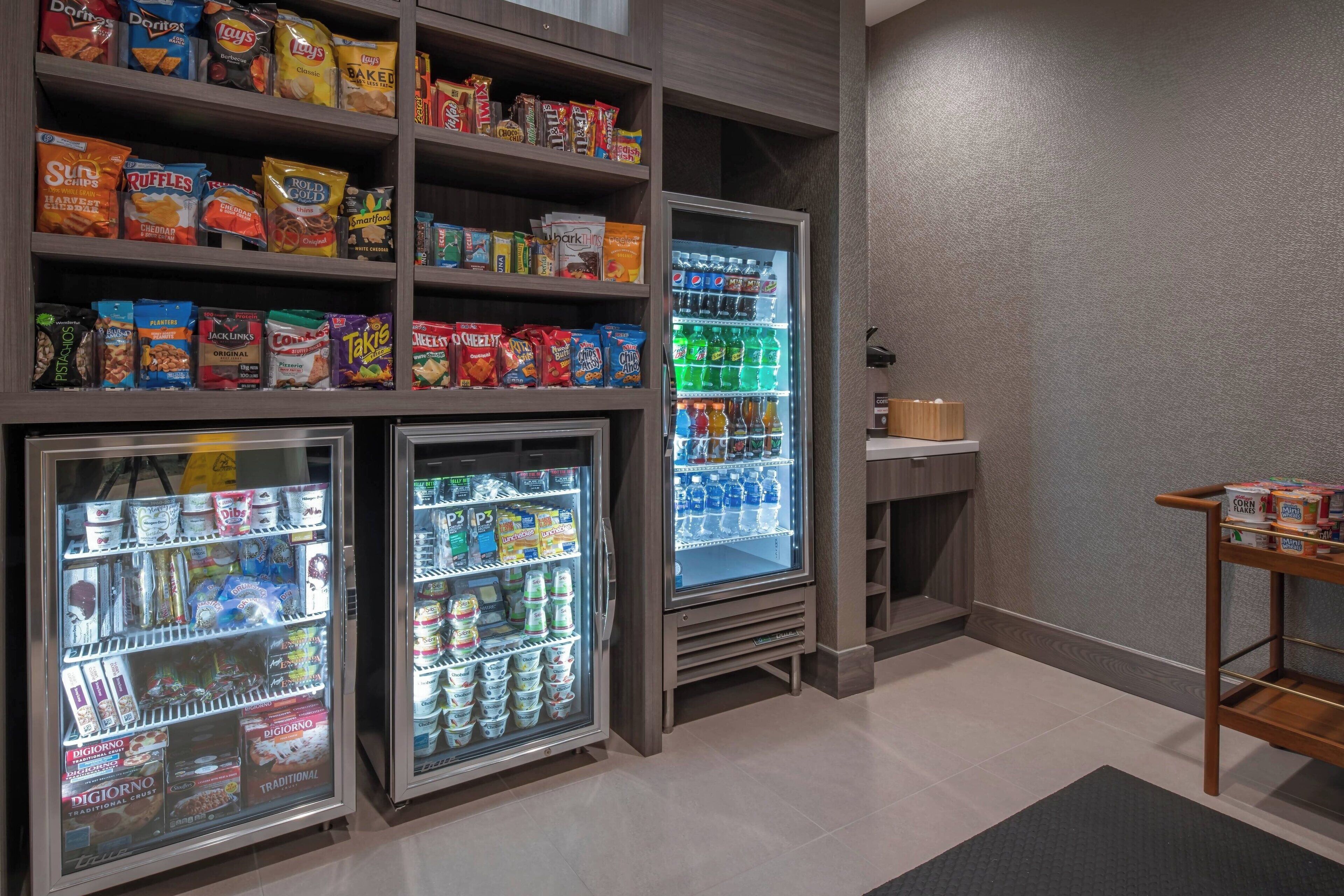 A snack and beverage vending area with various snack options and a refrigerated section.