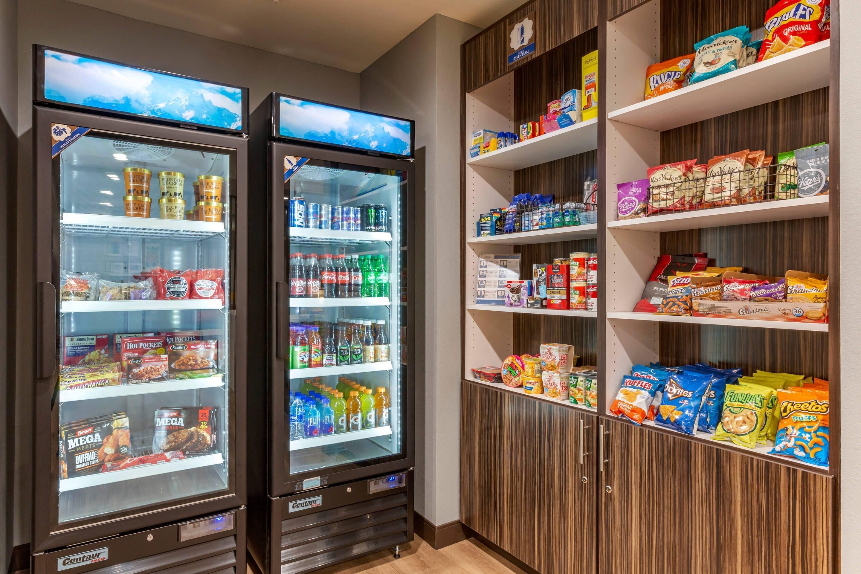 A vending machine area with various snacks and drinks, including hot pockets and Megas.