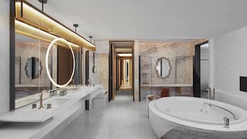 Un baño moderno con una bañera grande, dos lavamanos y un espejo con luz.
