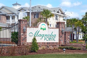 A brick building with a sign that reads "Magnolia Pointe." - Just an 8 Minute Drive to the Beach.... (Myrtle Beach)