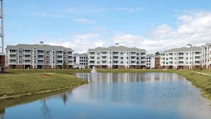 A multi-story residential building with a central courtyard and a small pond. - Just an 8 Minute Drive to the Beach.... (Myrtle Beach)