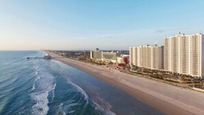 A coastal hotel with a beachfront view, a sandy beach, and a large body of water. - Ocean Front Two Bedroom Lock Off, Daytona Beach 2056760 (Daytona Beach)