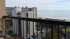 A balcony with a view of the ocean and a parking lot. - Ocean Dunes Condo Rental - Right Near the Sands (Myrtle Beach)