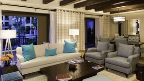 A modern living room with a sofa, armchairs, a coffee table, and a dining area. - Hacienda Beach Club Oceanview 4BR home– Prime Cabo Location (Cabo San Lucas,)