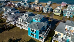 A coastal residential area with multiple two-story houses featuring balconies and a view of the ocean. - Five Minute Walk to the Beach Sleeps 11 (Cape Charles)