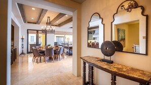 A spacious dining area with a chandelier, a large mirror, and a console table. - Hacienda Beach Club - 3 bedrooms, 8 people. Can also rent as 2 bedrooms (Cabo San Lucas,)