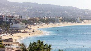 A beach with buildings in the background. - Hacienda Beach Club - 3 bedrooms, 8 people. Can also rent as 2 bedrooms (Cabo San Lucas,)