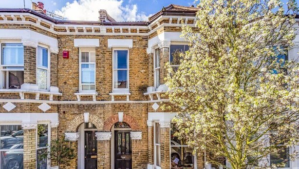A Victorian-style townhouse with a brick facade, bay windows, and a prominent entrance with a black door. - Large Spacious Family Home (sleeps 5), Parsons Green, LONDON (London)