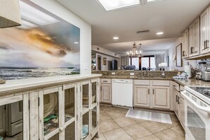 Enjoy cooking in this well-equipped kitchen with a large island and modern cabinetry.