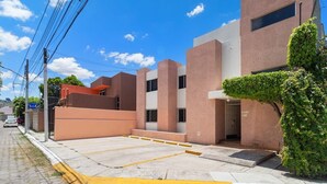 A modern building with a flat roof, rectangular windows, and a flat facade.