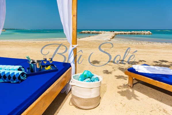 On the beach, sun loungers, beach towels