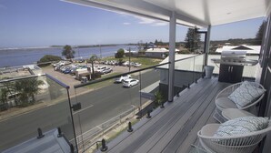 A balcony with a view of a parking lot and a body of water. - UNIT 2  OPPOSITE BEACH, RIVER ,HOTEL,CLUB,WALKING DISTANCE TO ALL VENUES ETC..
 (HARRINGTON)