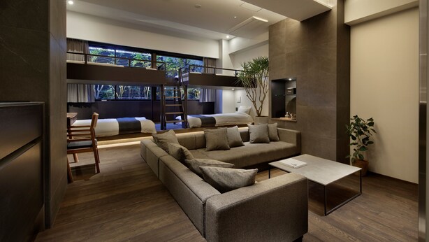 A modern living room with a sofa, a coffee table, and a bunk bed. - 20 Pieces (Kyoto)