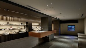A modern kitchen with a central island, built-in shelves, and a flat-screen TV mounted on the wall. - 20 Pieces (Kyoto)