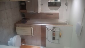 Experience a clean and functional bathroom with a toilet, sink, and towel rack.