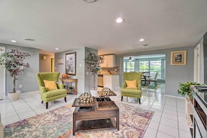 Relax in this stylish living room with a comfortable seating area, coffee table, and kitchen view.