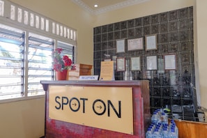 A reception desk labeled "SPOT ON" with a sign indicating reception is available. - Spot On 1847 Hotel Maya (Beru)