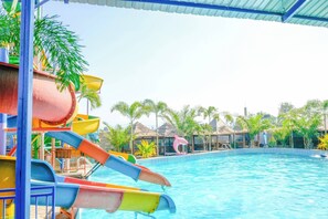 A water park with multiple slides and a pool.