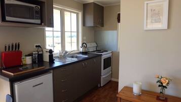 Fridge, microwave, coffee/tea maker, cookware/dishes/utensils