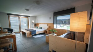 A modern room with a bed, a desk, and a window with a view. - eco boutique hotel A.M.S. Beagle Bled (Gorje)