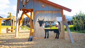 A wooden structure with a cow silhouette and a sign. - Dorner Hof (Sibratsgfaell)