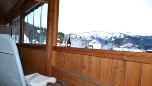 A wooden cabin with a balcony overlooking a snowy mountain landscape. - Dorner Hof (Sibratsgfaell)