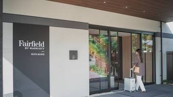 A modern hotel entrance with a sign reading "Fairfield by Marriott Gifu Mino."