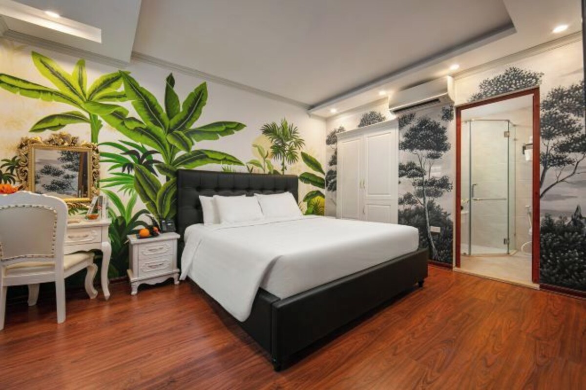 A bedroom with a bed, a nightstand, a chair, and a wardrobe.