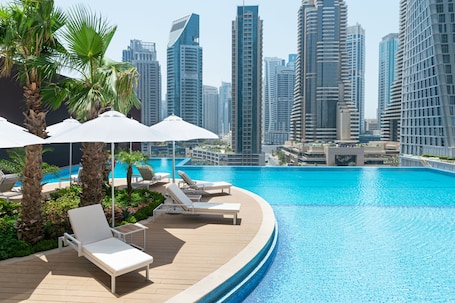 Outdoor pool, pool umbrellas, pool loungers. Jumeirah Living Marina Gate