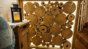 A wooden cabinet with a glass front displaying numerous wooden logs. - Willa Bachledowka (Zakopane)