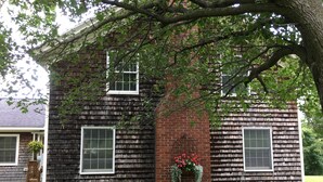A two-story house with a brick chimney, a window with a flower box, and a tree in front. - Just 3 miles Cooperstown, Hall of Fame, 2.5 miles to Baseball Dreams Park. (Cooperstown)