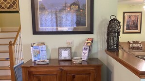 A wooden cabinet with framed pictures, a decorative lantern, and a framed photograph on a wall. - Just 3 miles Cooperstown, Hall of Fame, 2.5 miles to Baseball Dreams Park. (Cooperstown)