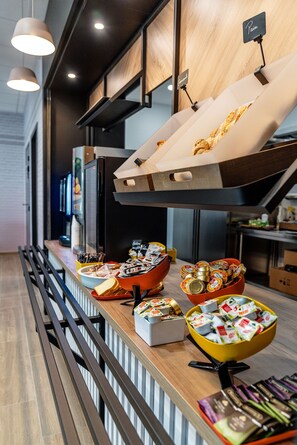 A buffet area with various food items and condiments. - B&B HOTEL Poitiers Aéroport (Biard)