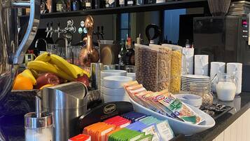 A bar area with shelves of liquor bottles, a coffee machine, and various food items like bananas and cereal.