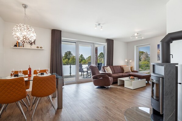 Relax in this stylish living room with a sofa, coffee table, and fireplace, offering a view of the outdoors.