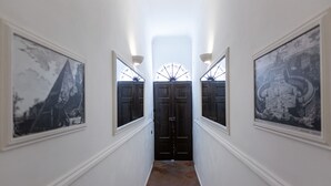 A hallway with two doors and framed pictures on the walls. - Amazing New Penthouse with Terrace Jewish Ghetto  (Roma)