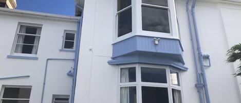 A corner building with a bay window and a dormer window.