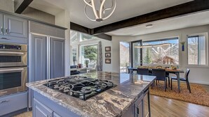 Cocina moderna con encimeras de granito, electrodomésticos de acero inoxidable y una isla grande.