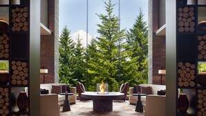 A modern lounge area with a round table, sofas, and a fireplace. - Higashiyama Niseko Village, a Ritz-Carlton Reserve (Niseko)