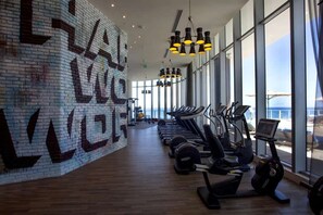 A gym with exercise equipment and large windows. - Luxurious Ocean View 2 Bedroom Escape (Hollywood)