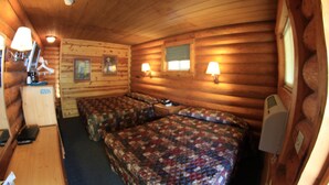 A cabin-style room with two beds, a small kitchenette, and a wooden ceiling. - Liberty Belle Lodge (Aladdin)