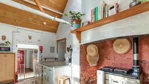 A kitchen with a wooden ceiling, a stove, a sink, and a countertop. - Sheepwash Square House (Sheepwash, near Beaworthy)