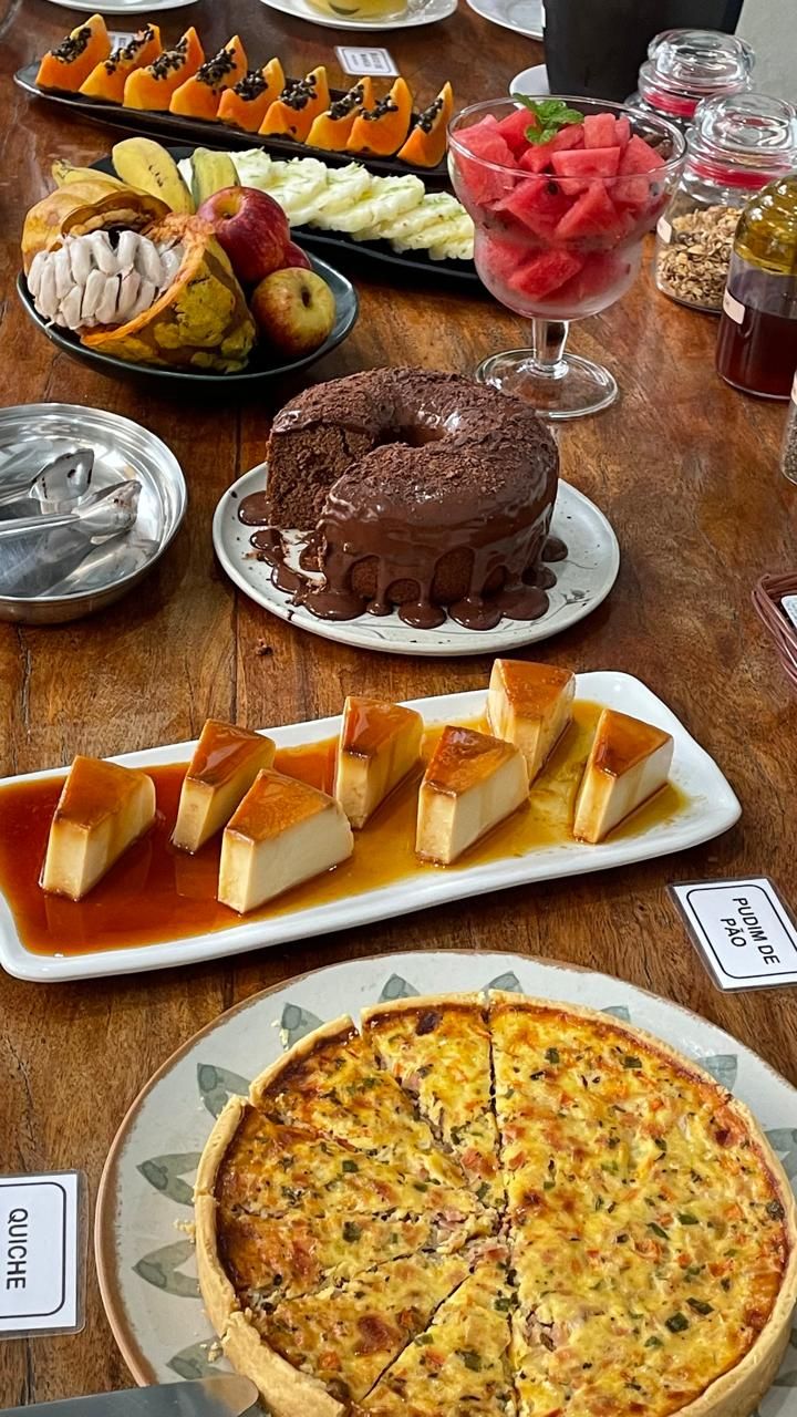 Diverse desserts, waaronder chocoladetaart, crème brûlée en een quiche, op een houten tafel.
