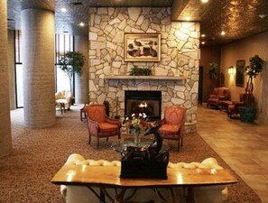 Cozy gathering space with a fireplace, armchairs, and a coffee table.
