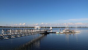 A marina with boats docked, a pier, and a calm water body under a clear sky. - Luxus Ferienwohnung für 6 P. mit Sauna & Holzofen - am Wasser und in Strandnähe (Geeste)