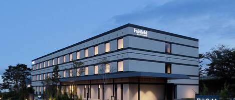 A modern hotel building with a flat roof, multiple floors, and a sign indicating it is a Marriott property.