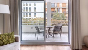 A modern apartment with a sliding glass door leading to a balcony with outdoor furniture. - Large 2-Bed Apartment | Paris Vincennes | Sleeps 6 (Paris)
