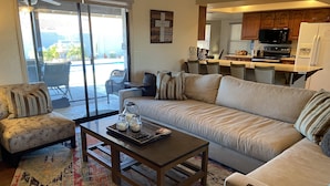 A living room with a sofa, armchairs, a coffee table, and a rug. - Beautiful Backyard Oasis Lake House (Lake Havasu City)