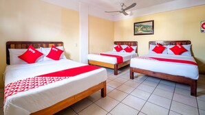 A hotel room with three beds, each with red and white bedding, and a ceiling fan. - OYO Hotel Betsua Vista Hermosa, Huatulco (Santa María Huatulco)